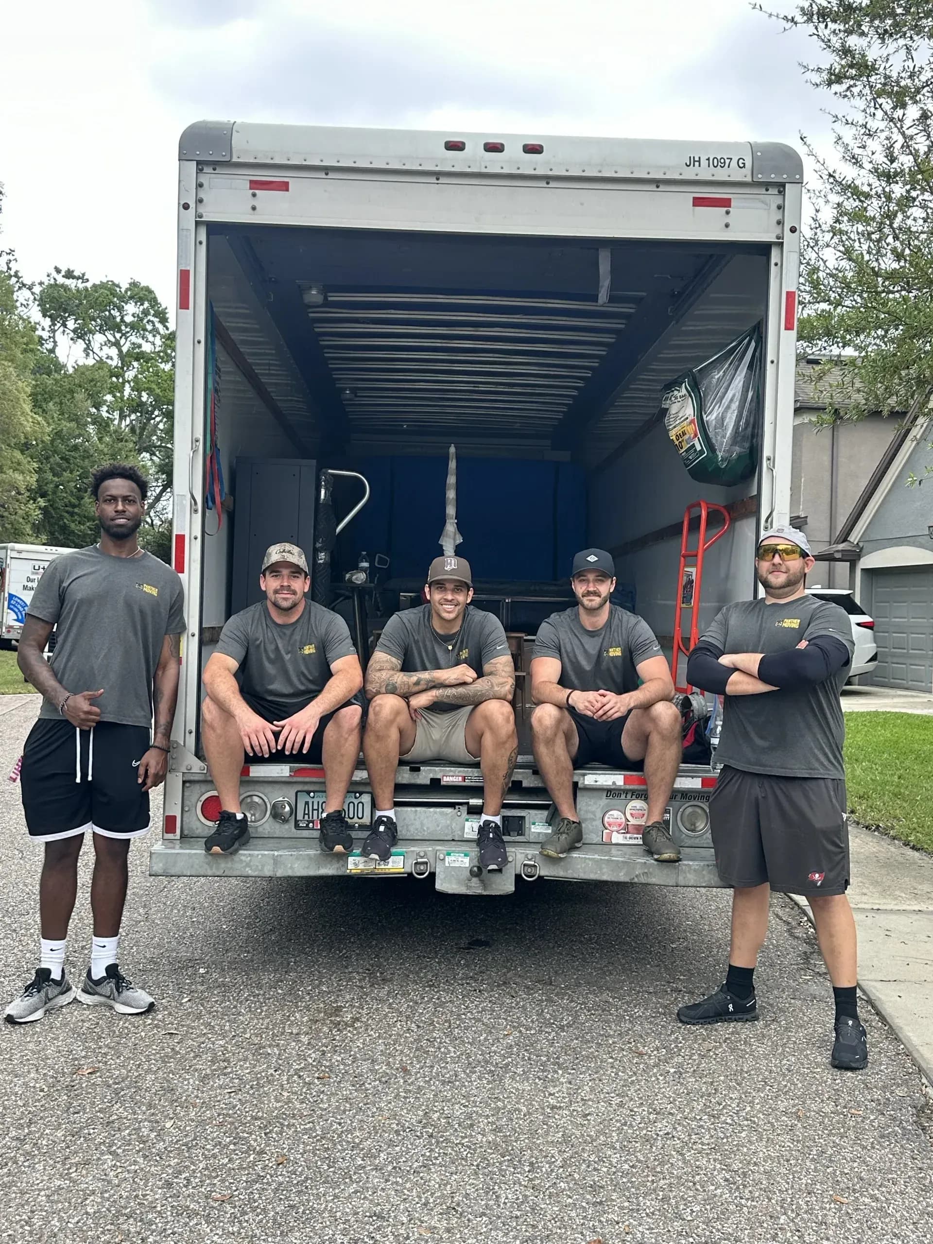 Panther Moving crew standing in front of the moving truck ready for a job